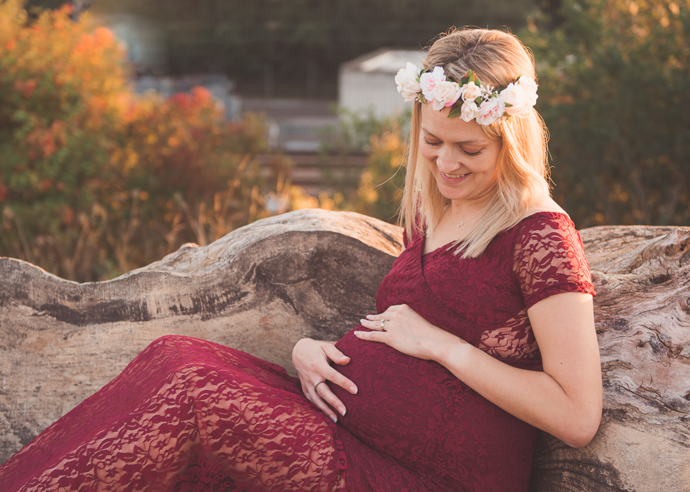 maternity outdoor photo wooden bench red dress