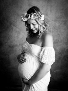 studio maternity photo in a white dress