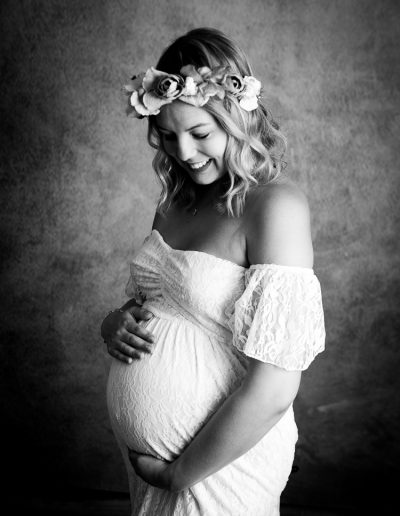 studio maternity photo in a white dress