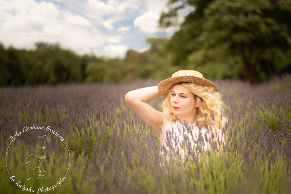 wearing a sun hat in a lavender field